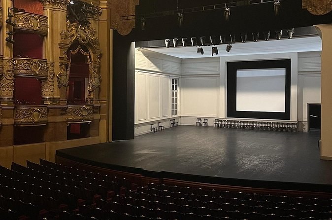 A bare stage inside the auditorium, seen from the stalls