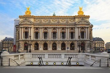 Gilded bronze figures and the green copper dome above the facade