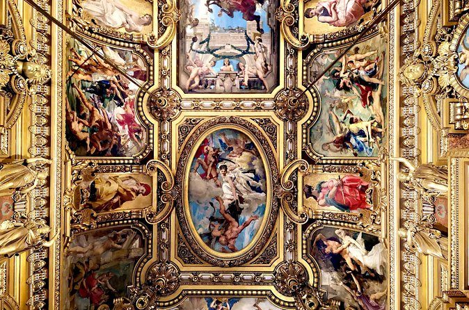Painted panels and gold moulding across the Grand Foyer ceiling