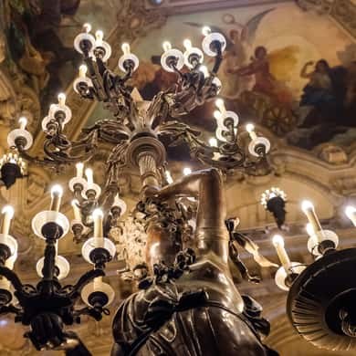 Chandeliers hanging beneath the painted ceiling of the Grand Foyer
