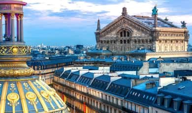The green dome of the Palais Garnier seen out over the Paris rooftops
